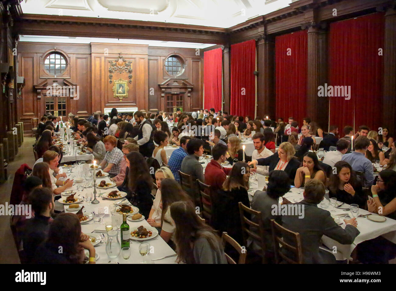 Students having dinner in the dining hall of Somerville College in Oxford. From a series of