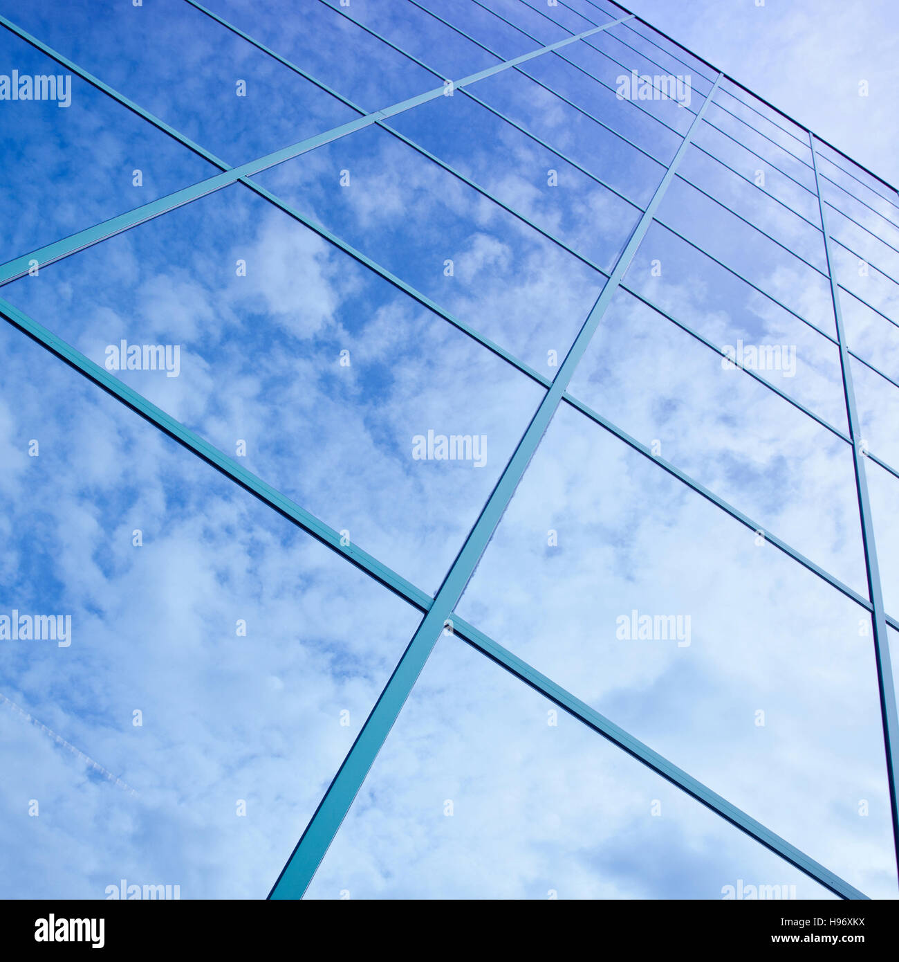 reflections of clouds and blue sky in facade of office building Stock ...