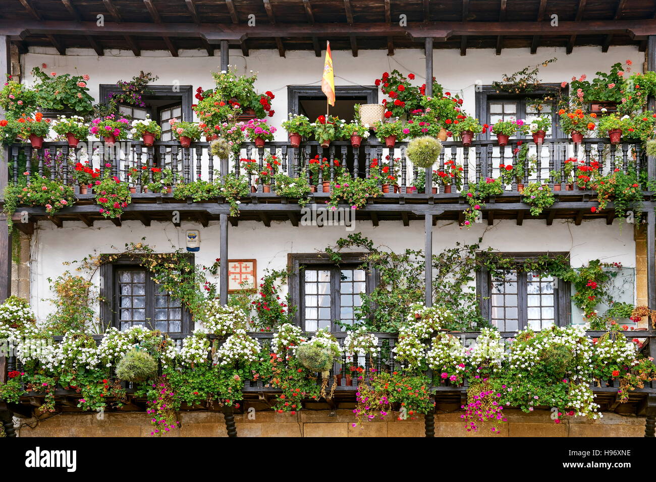 Window flower decoration, flowered balcony at Santillana del Mar, Cantabria, Spain Stock Photo