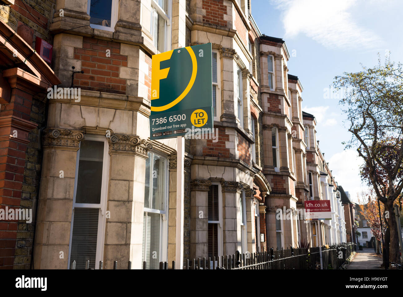 Estate agent signs outside a row of Victorian terraced houses in a street in London, England, UK. Stock Photo