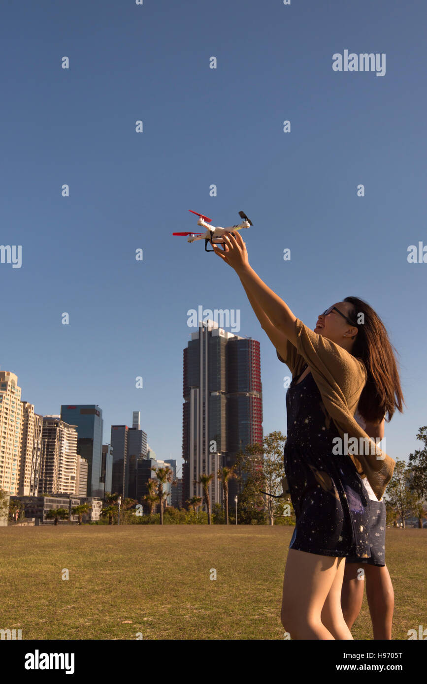 Two people in a Sydney park playing with a drone Stock Photo
