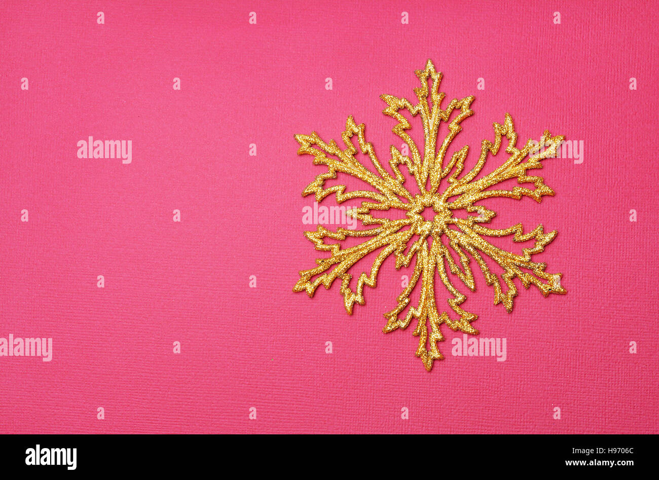 Pink Christmas background with decorative golden snowflake Stock Photo ...