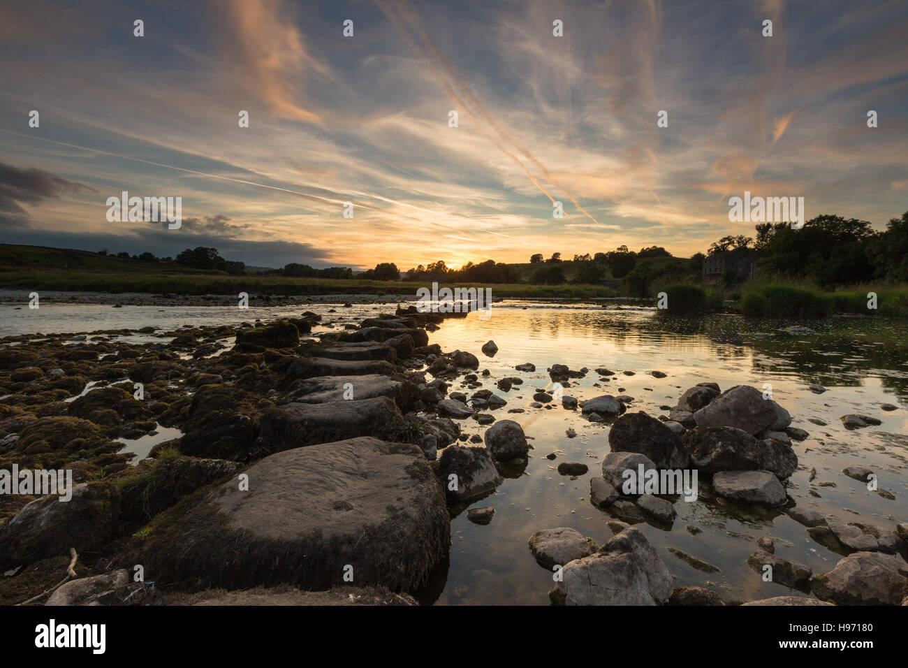 View of stepping stones across River Wharfe to Linton Church, Linton Falls, Wharfedale, Yorkshire Dales, UK Stock Photo