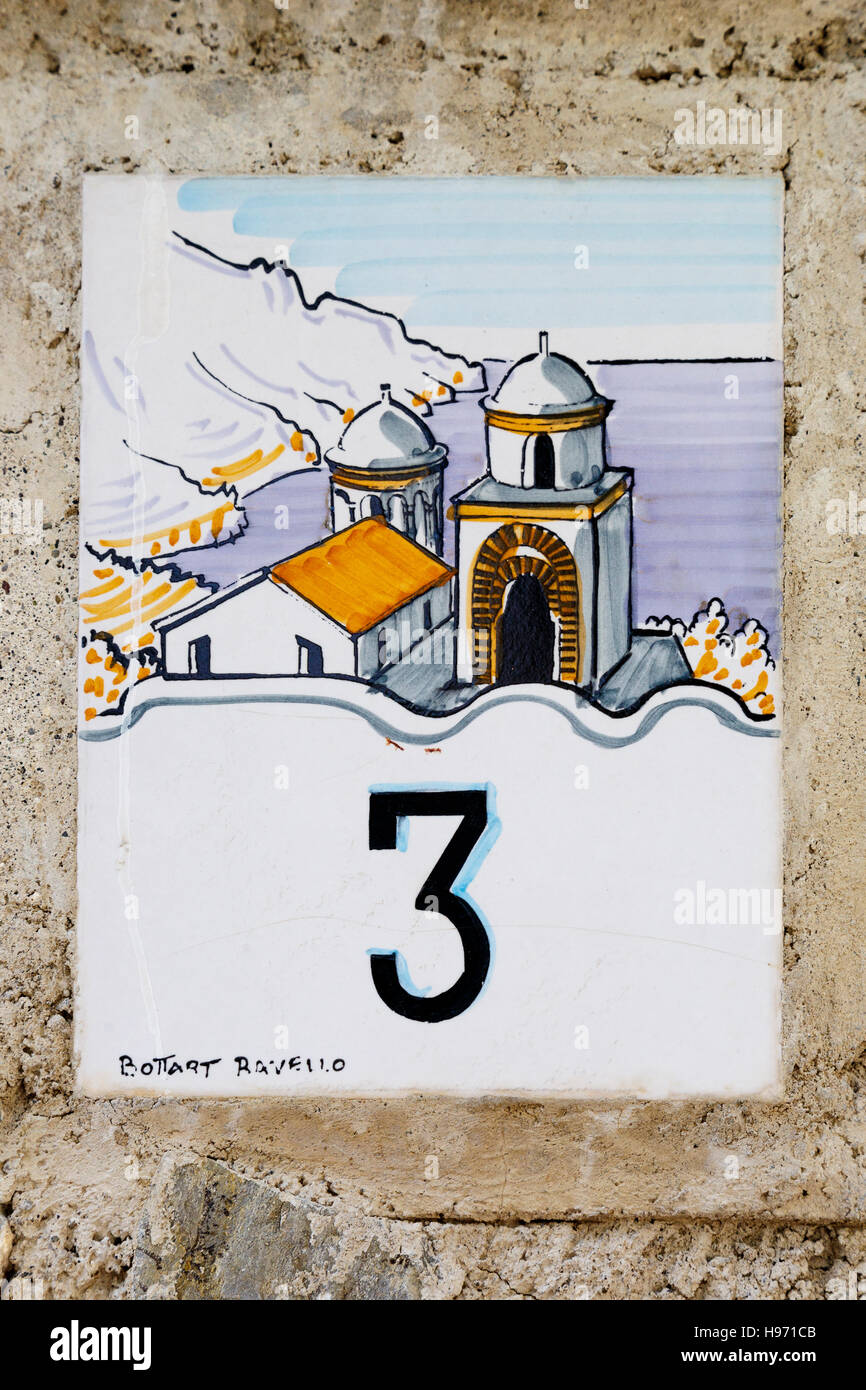 Traditional ceramic tile denoting the house number with the iconic view of Our Lady of The Annunciation church, Ravello, Italy. Stock Photo