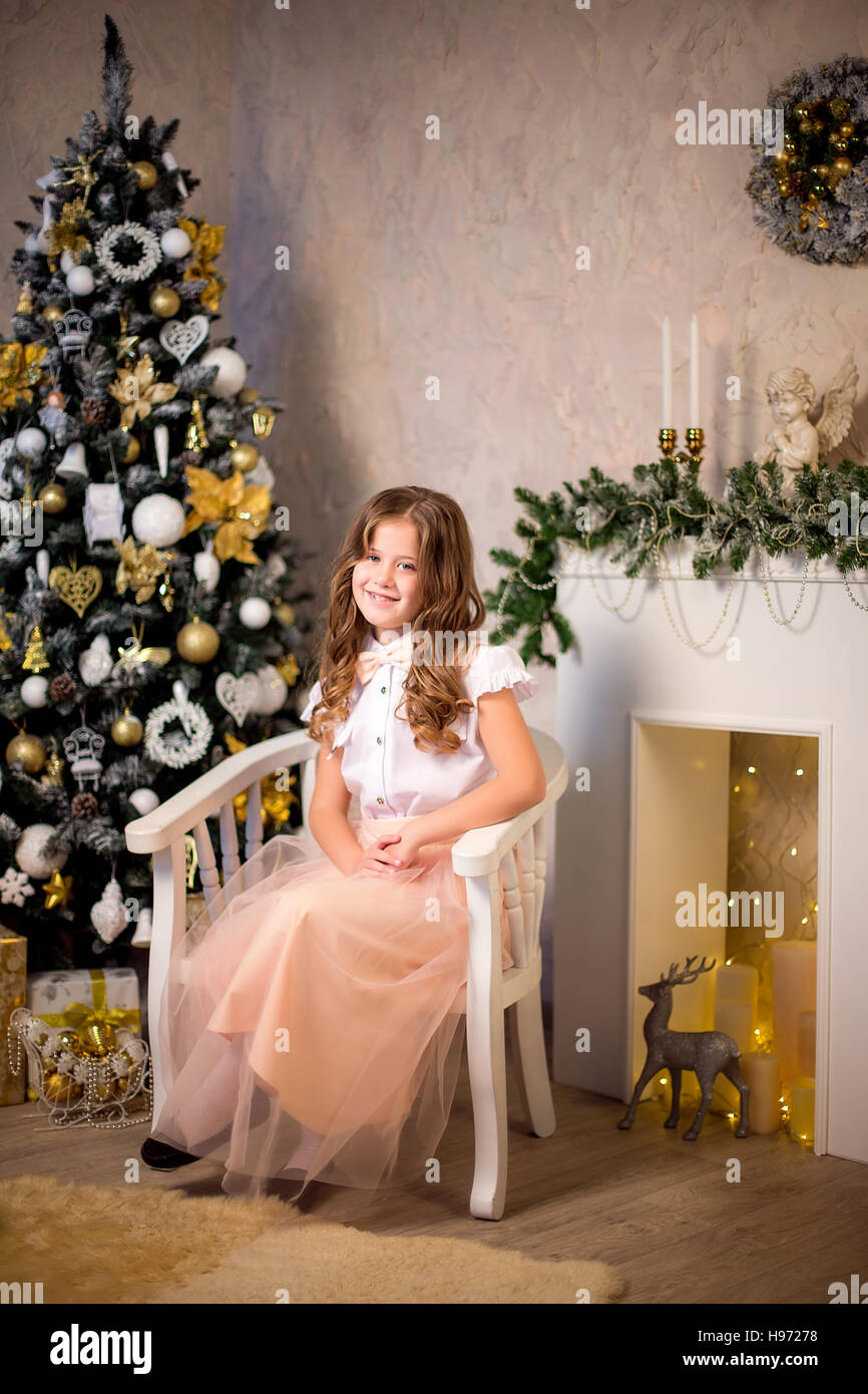 Little smiling girl sitting in soft chair Stock Photo - Alamy