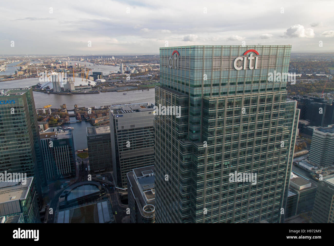 UK headquarters of CITI bank at 25 Canada Square, Canary Wharf, London, with the O2 arena and River Thames in the background. Stock Photo