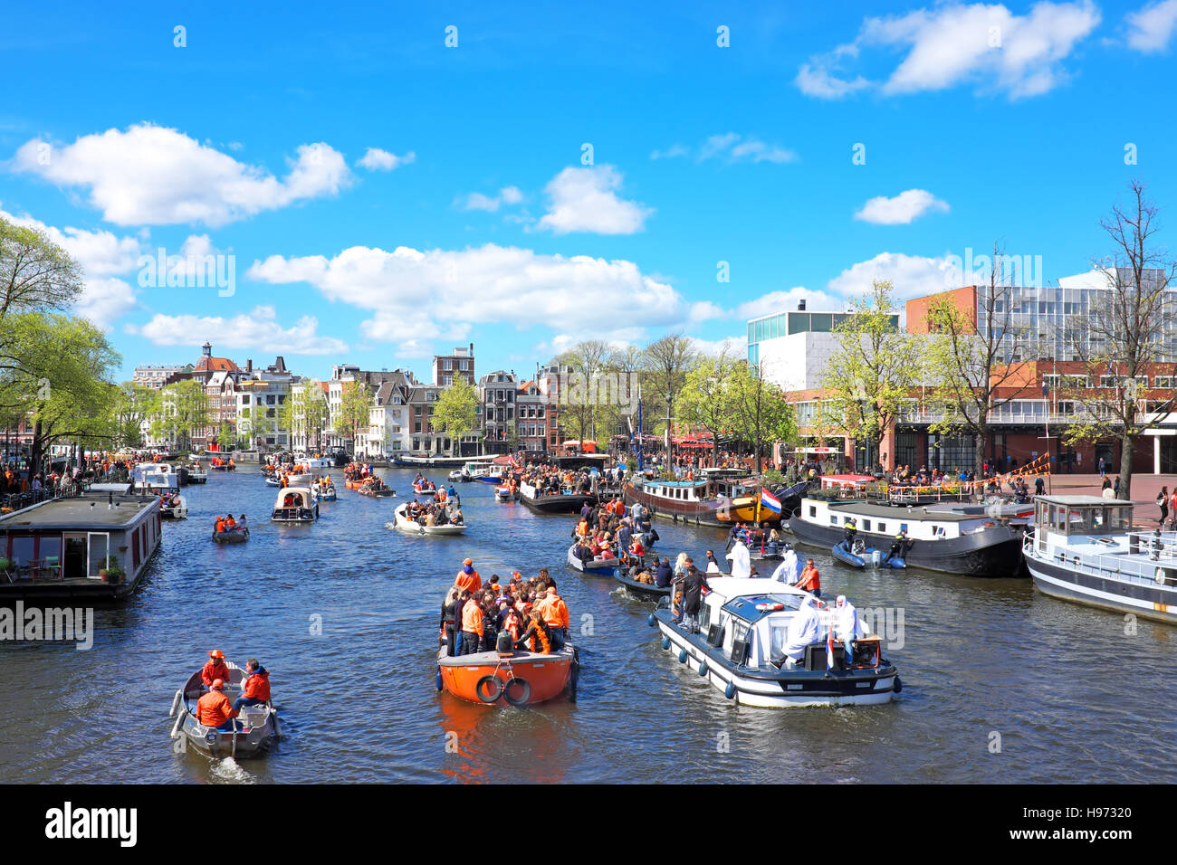 APRIL 27: Amsterdam canals full of boats and people in orange during the celebration of kings day on April 27, 2015 in Amsterdam, The Netherlands Stock Photo
