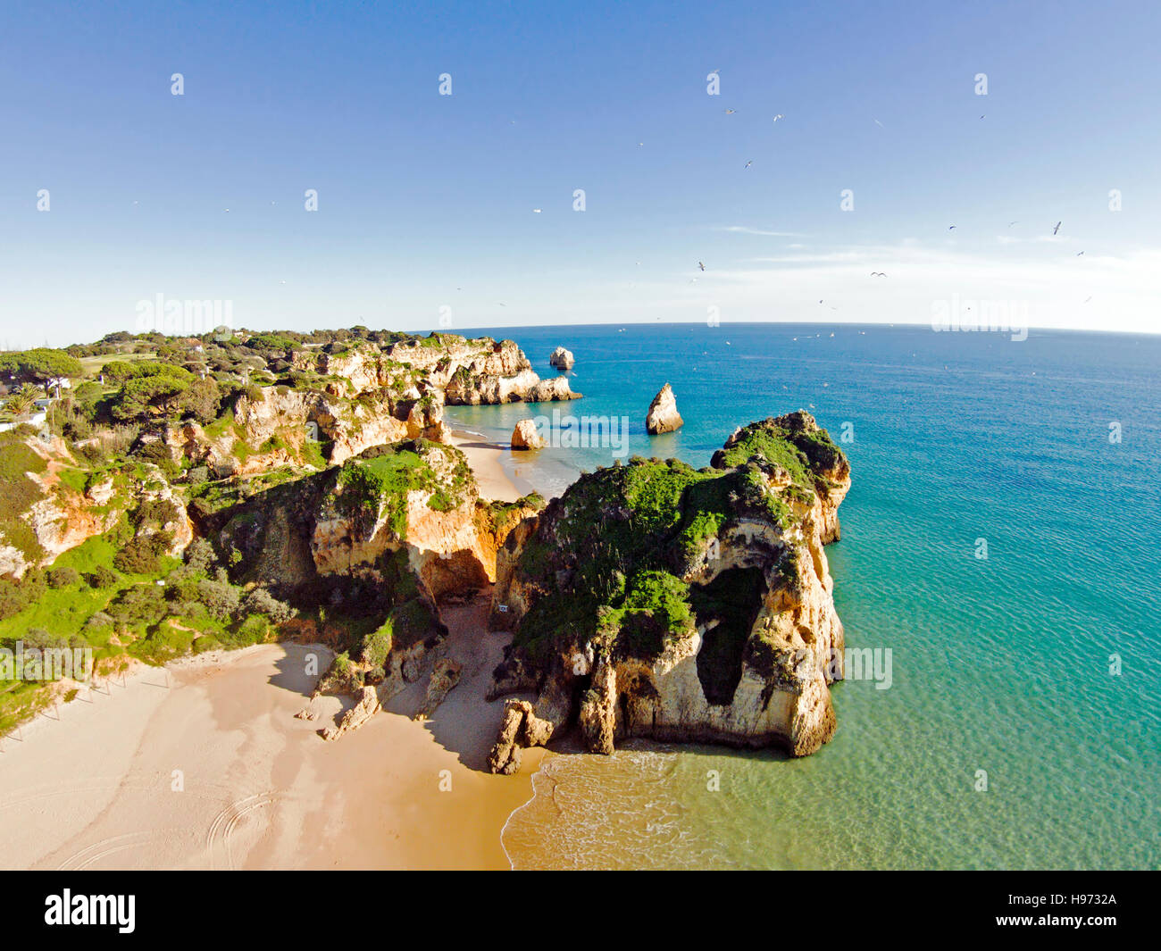 Aerial from rocks and ocean at Praia tres Irmaos in Algarve Portugal Stock Photo