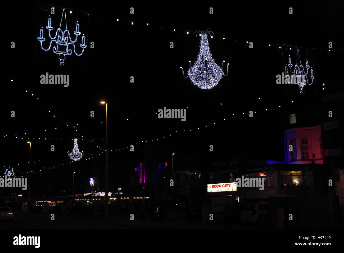 White chandelier between two blue candelabras above Central Promenade