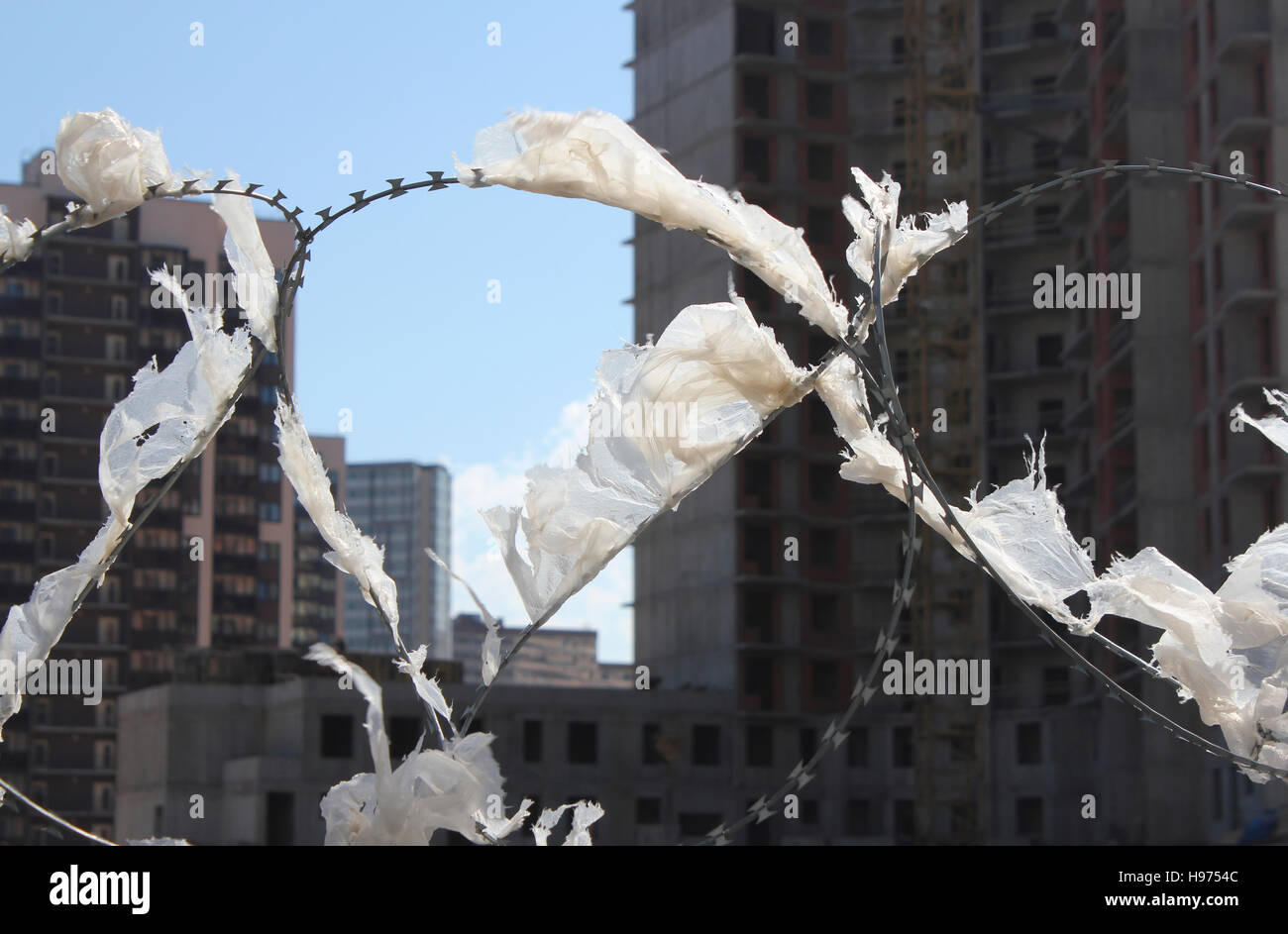 barbed wire with polyethylene on construction site Stock Photo