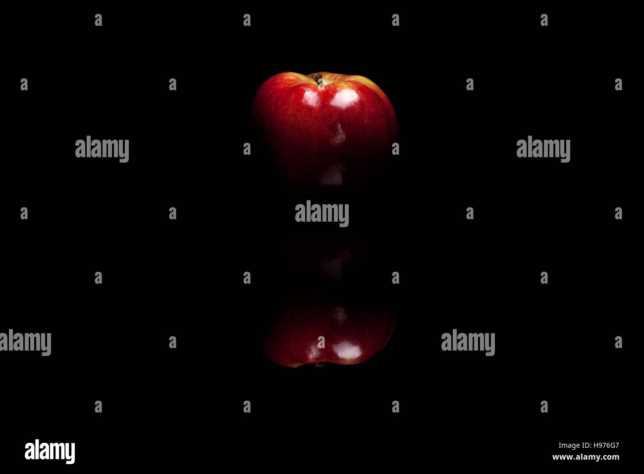 Red apple isolated on black reflective background Stock Photo