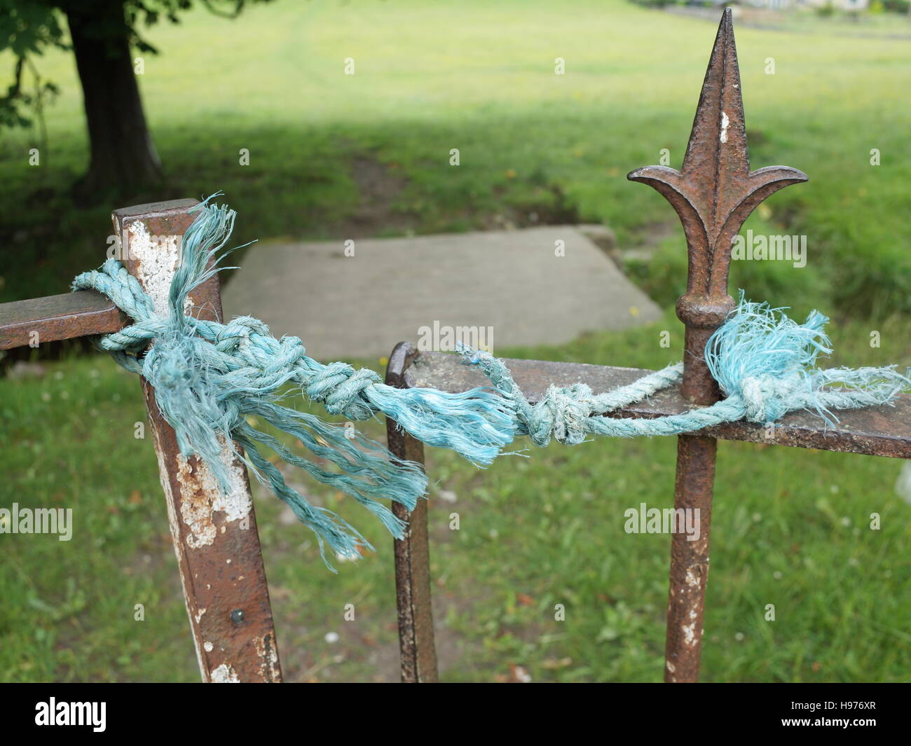 Gate tied shut with Blue Nylon Rope Stock Photo