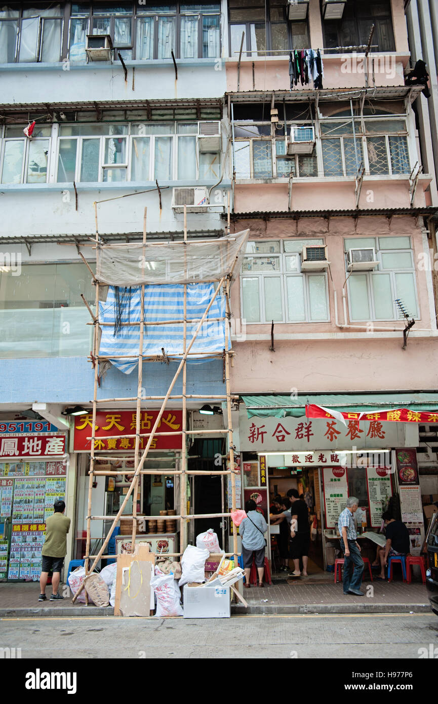 View of building in Hong Kong, with some bamboo scaffolding, stores on