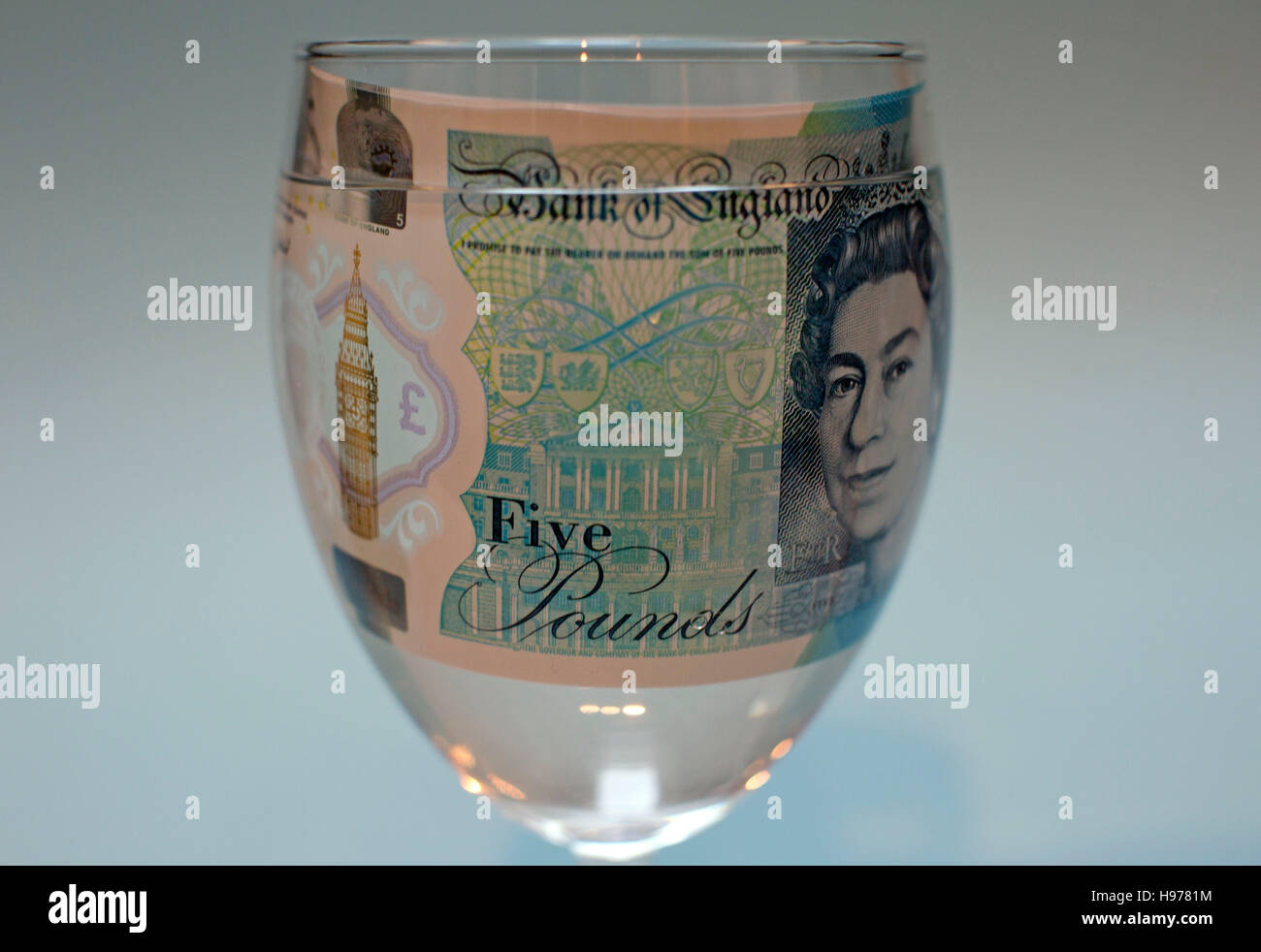 New polymer fiver pound note in glass of water, London Stock Photo