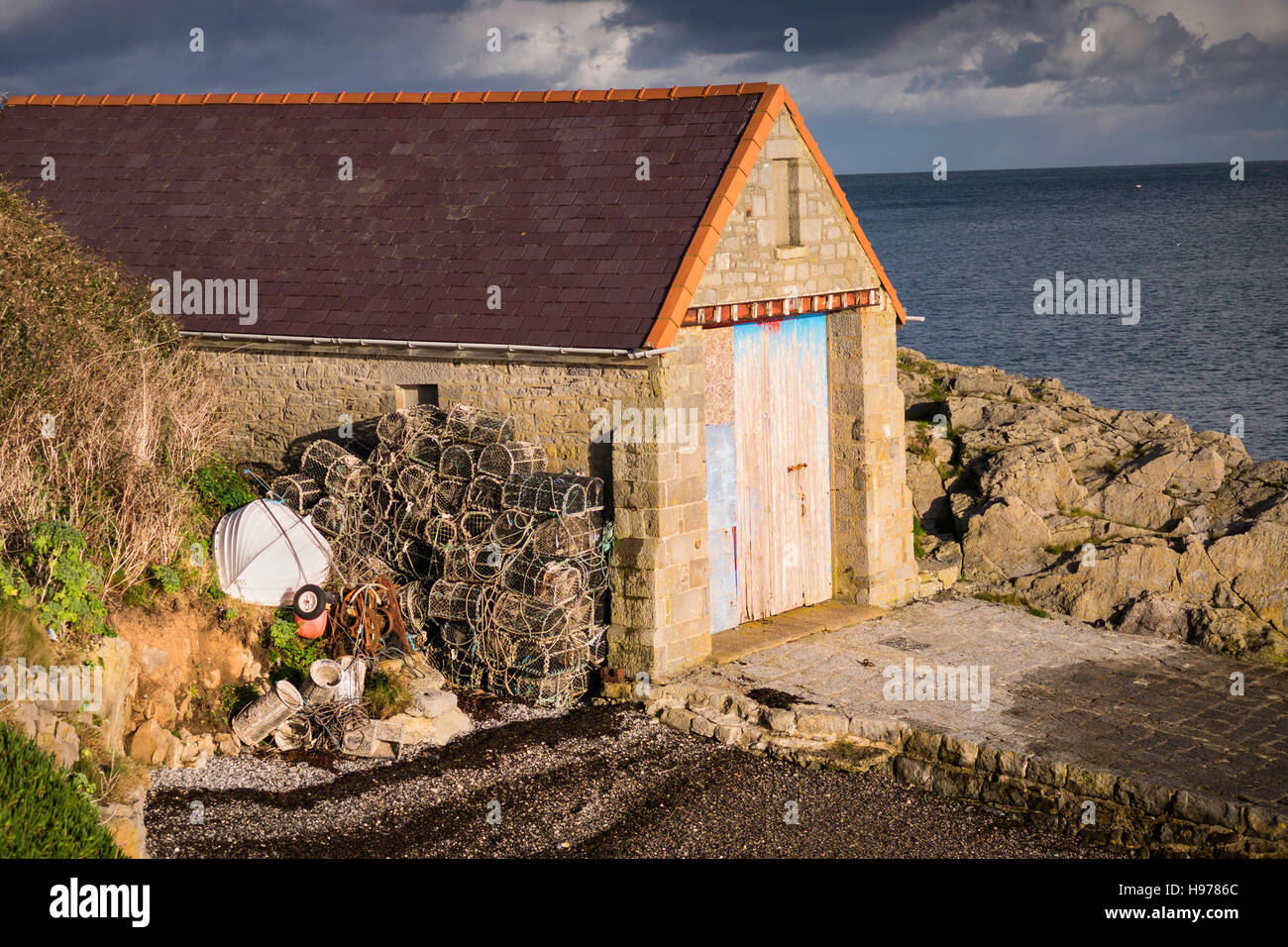 Old Lifeboat house Moelfre Anglesey North Wales Uk. Lobster pots. nets