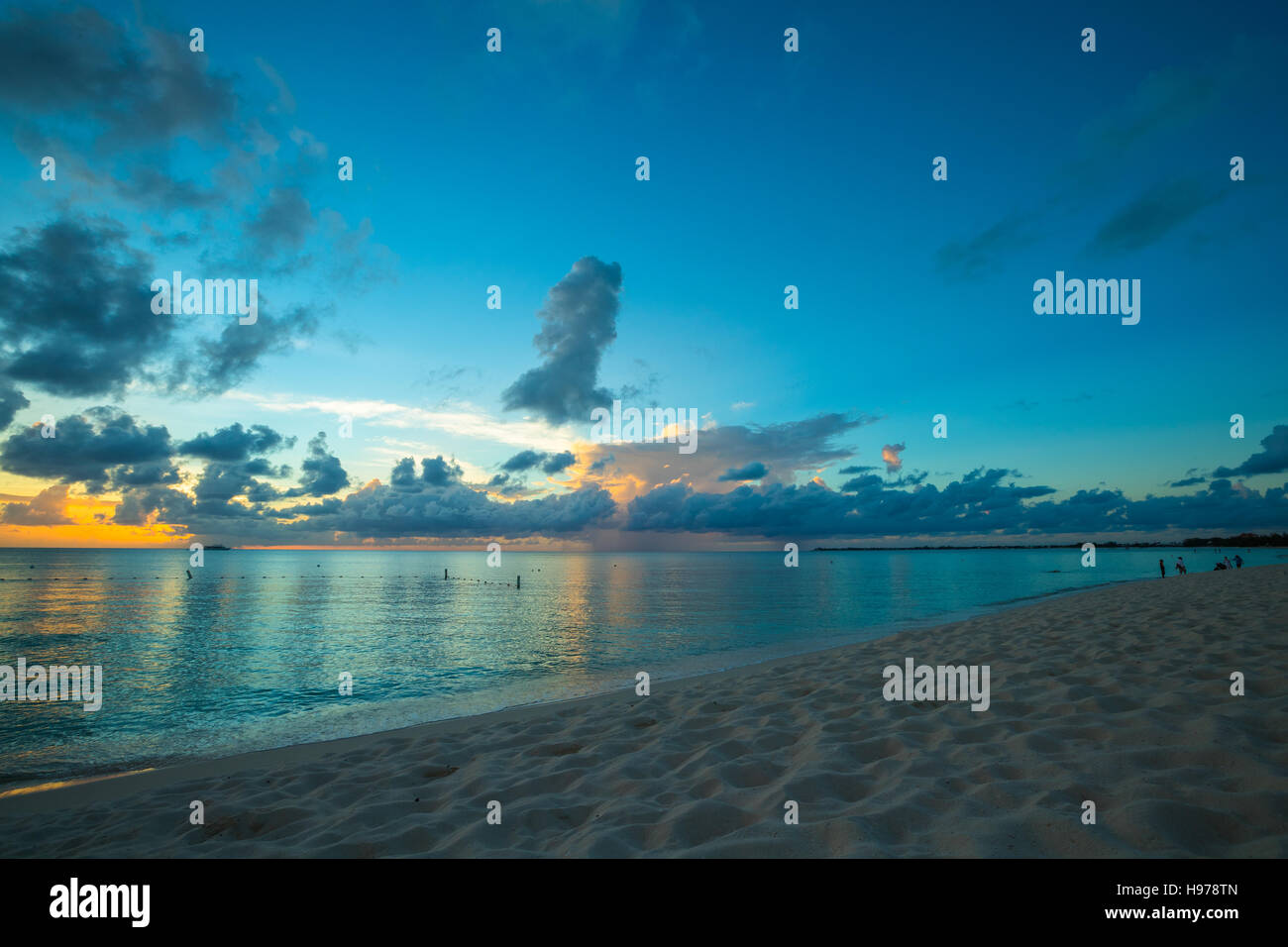 sunset over a tropical sea with golden sky and clouds Stock Photo - Alamy