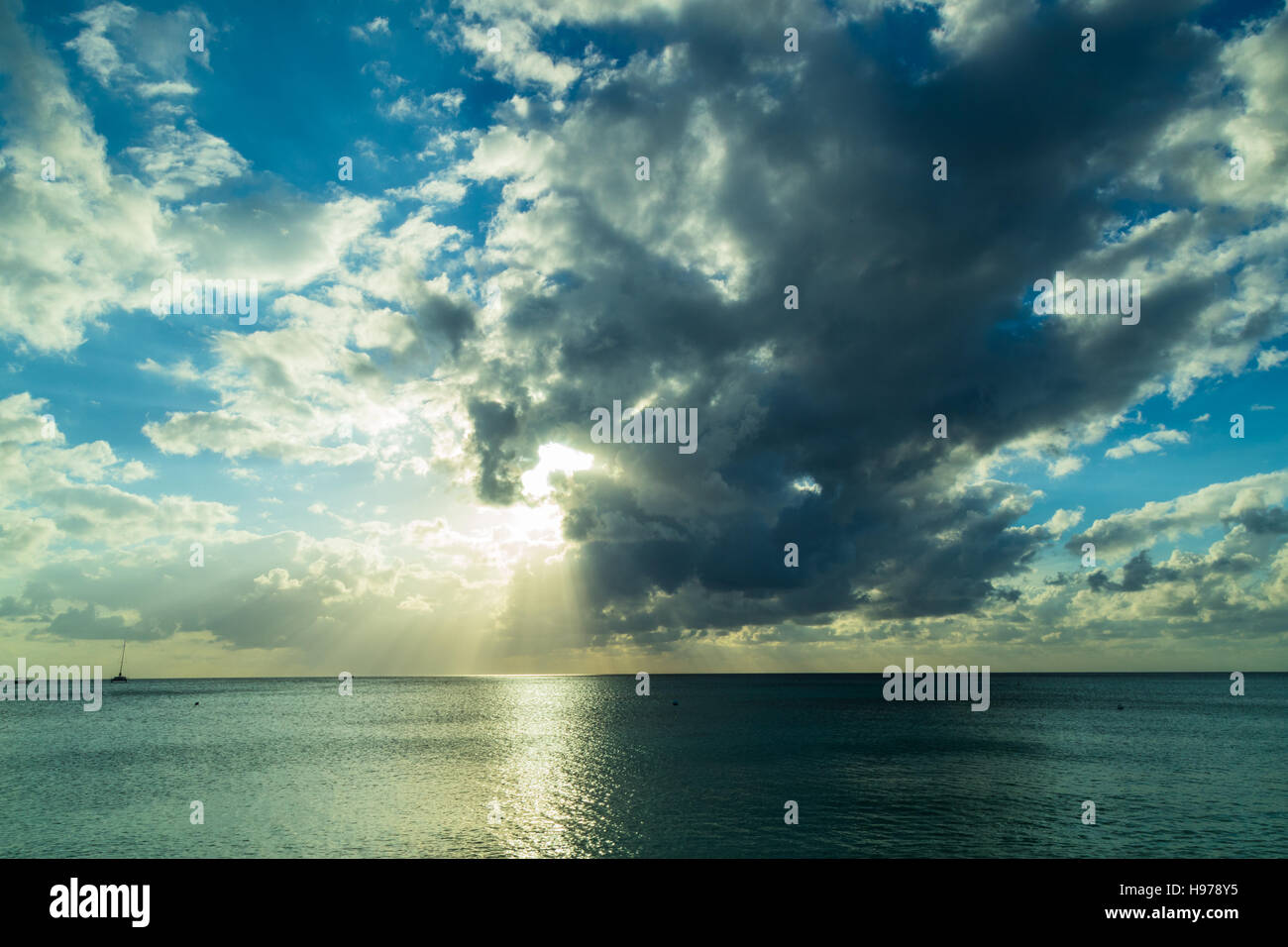 sunset over a tropical sea with golden sky and clouds Stock Photo - Alamy