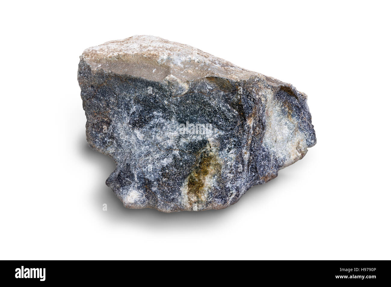 Piece of broken fractured igneous rock on white showing the texture of the stone in a concept of natural resources and geology Stock Photo