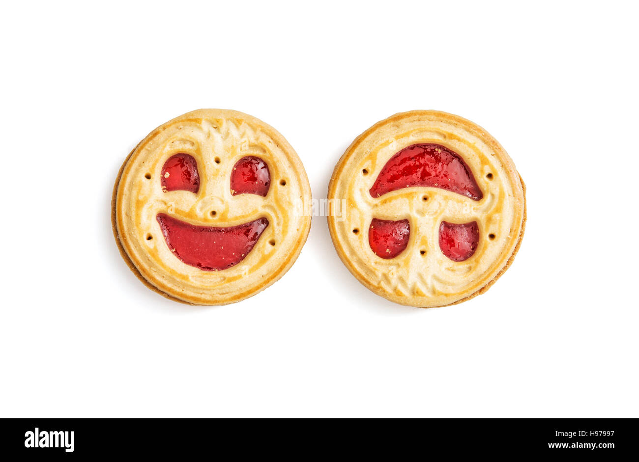 Two round jam biscuits smiling faces isolated on the white background. Humorous sweet food. Tasty cookies. Good mood. Stock Photo
