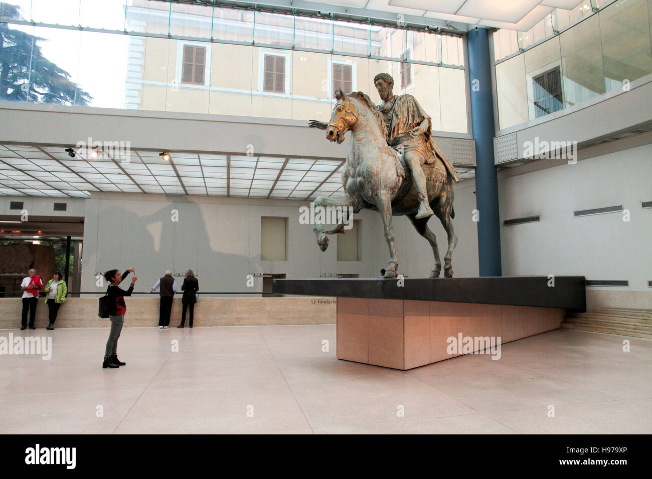 Tourists looking Emperor Marco Aurelio on horseback italy, capitoline museums, musei capitolini art heritage touristic landmark Stock Photo