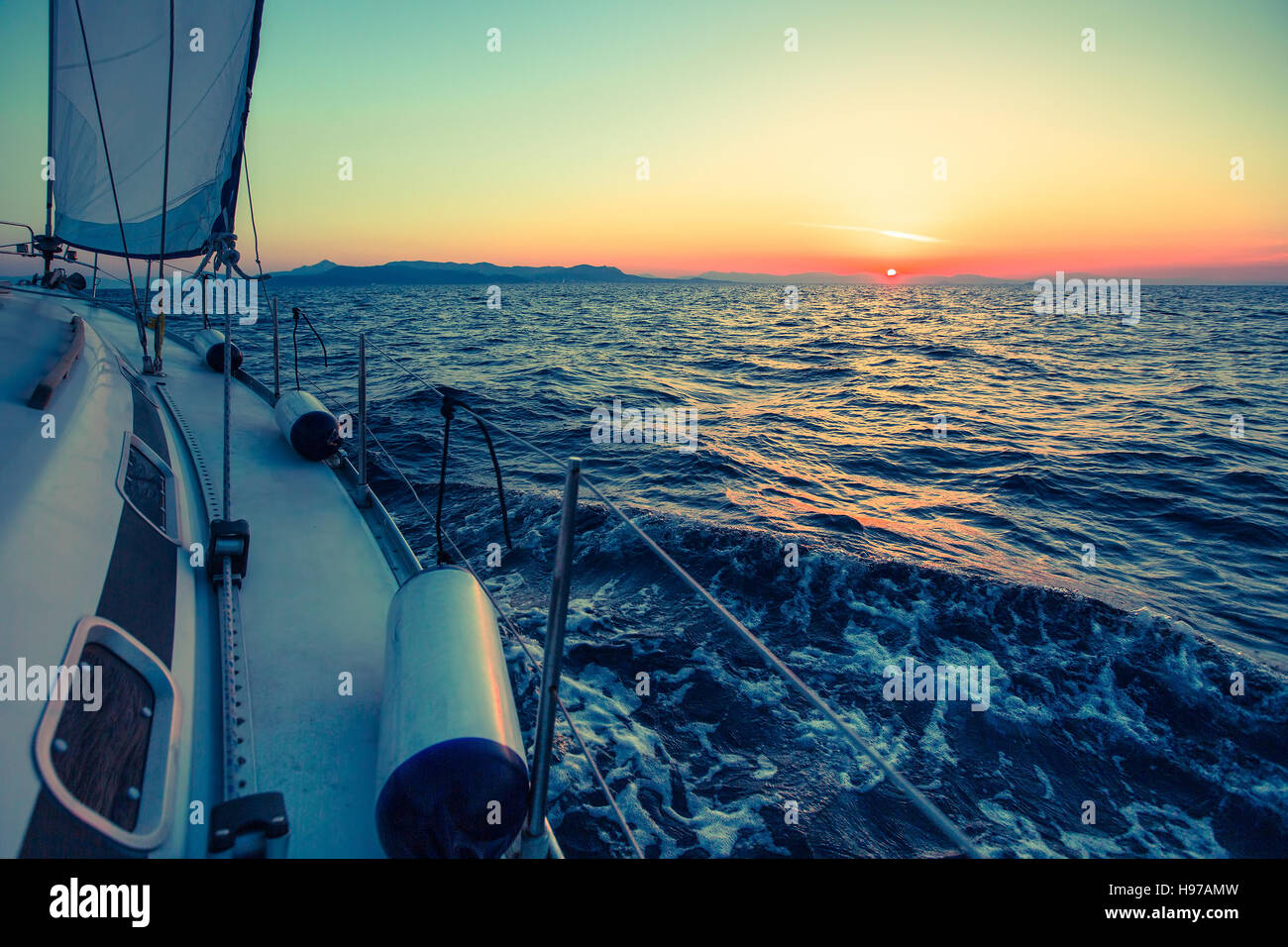 Amazing sunset at sea on a sailing yacht Stock Photo - Alamy