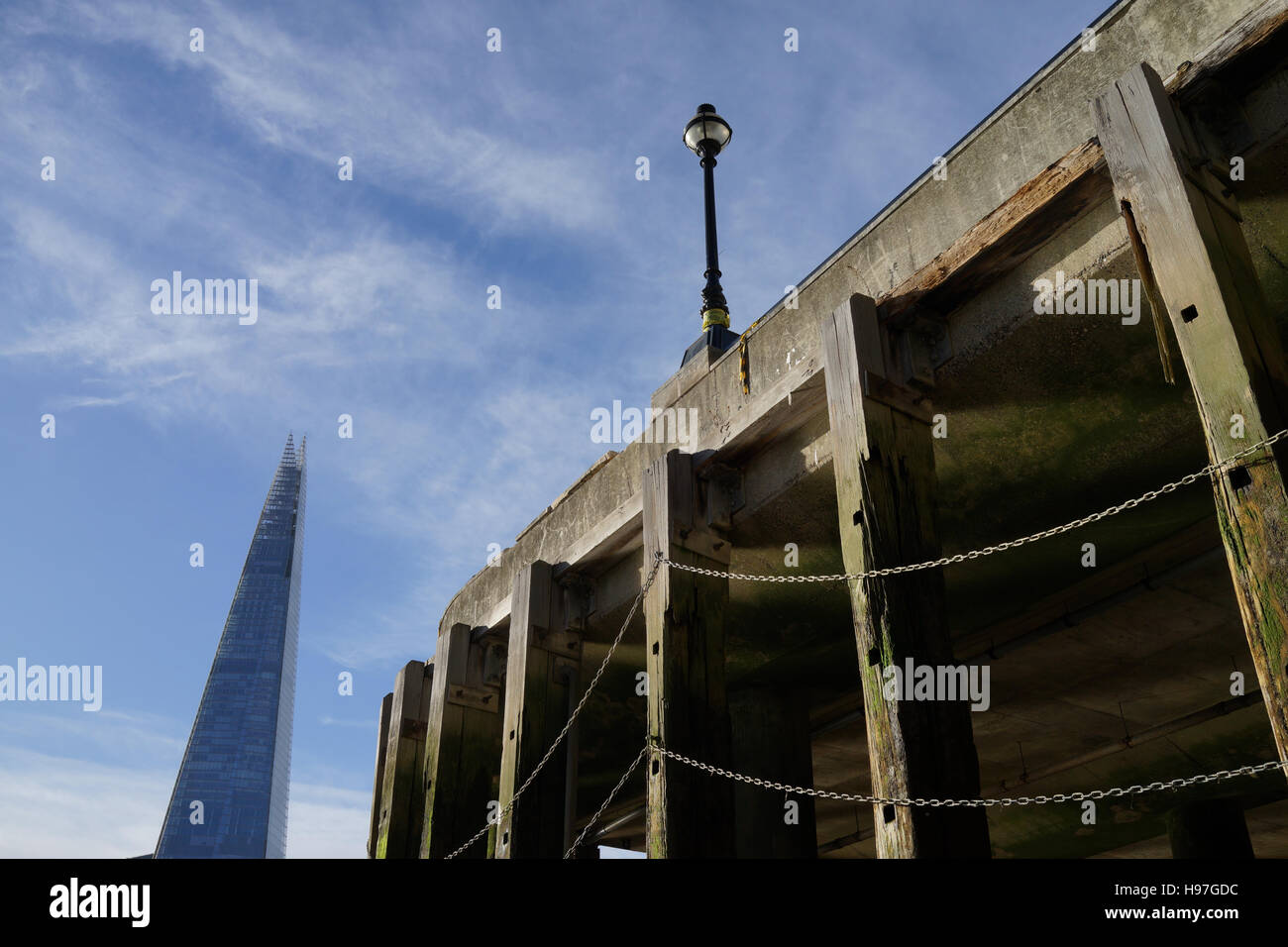 A quay on the Thames at low tide, with the Shard building visible. Stock Photo