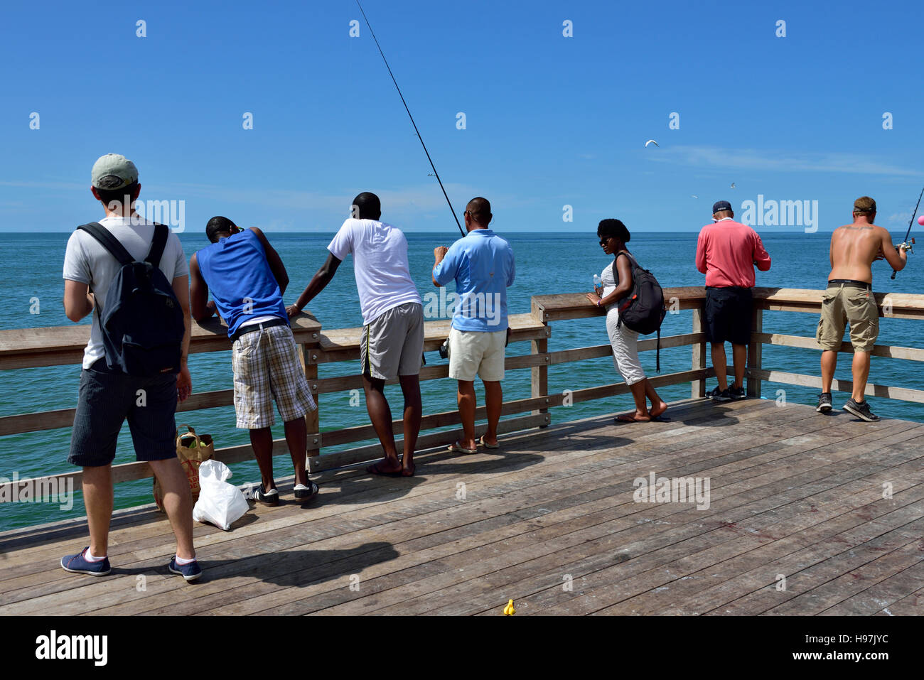 People watching fishermen at end of Naples pier, Florida, USA Stock Photo