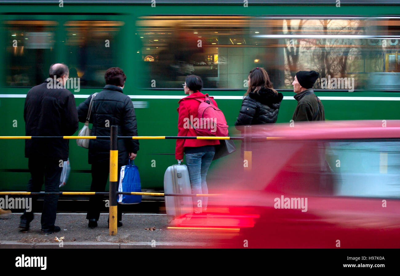 Belgrade, Serbia - November 18, 2016: Tram arriving at a tram stop and people waiting to board, motion blur Stock Photo