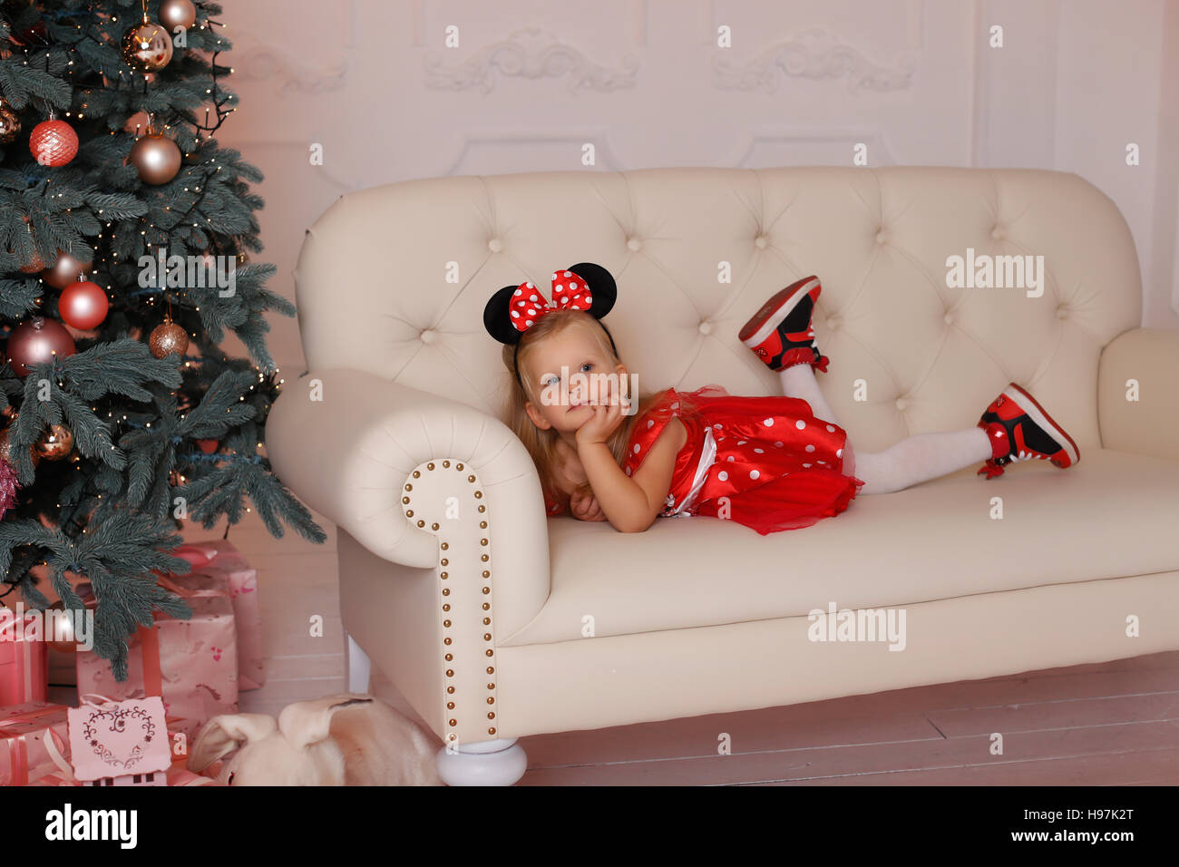 The girl in a mouse costume at Christmas Stock Photo