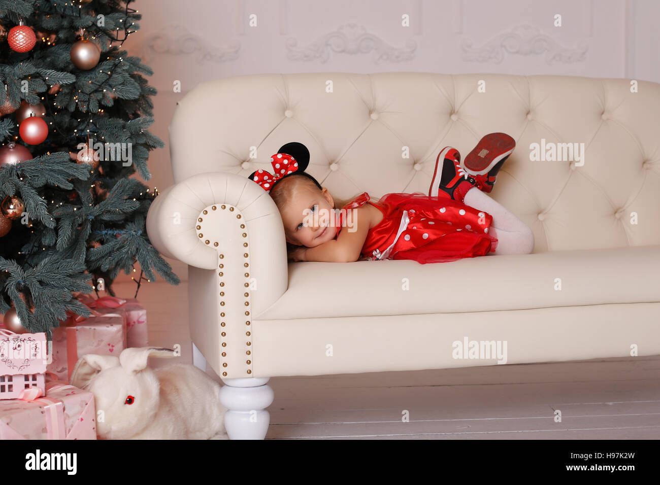 The girl in a mouse costume at Christmas Stock Photo