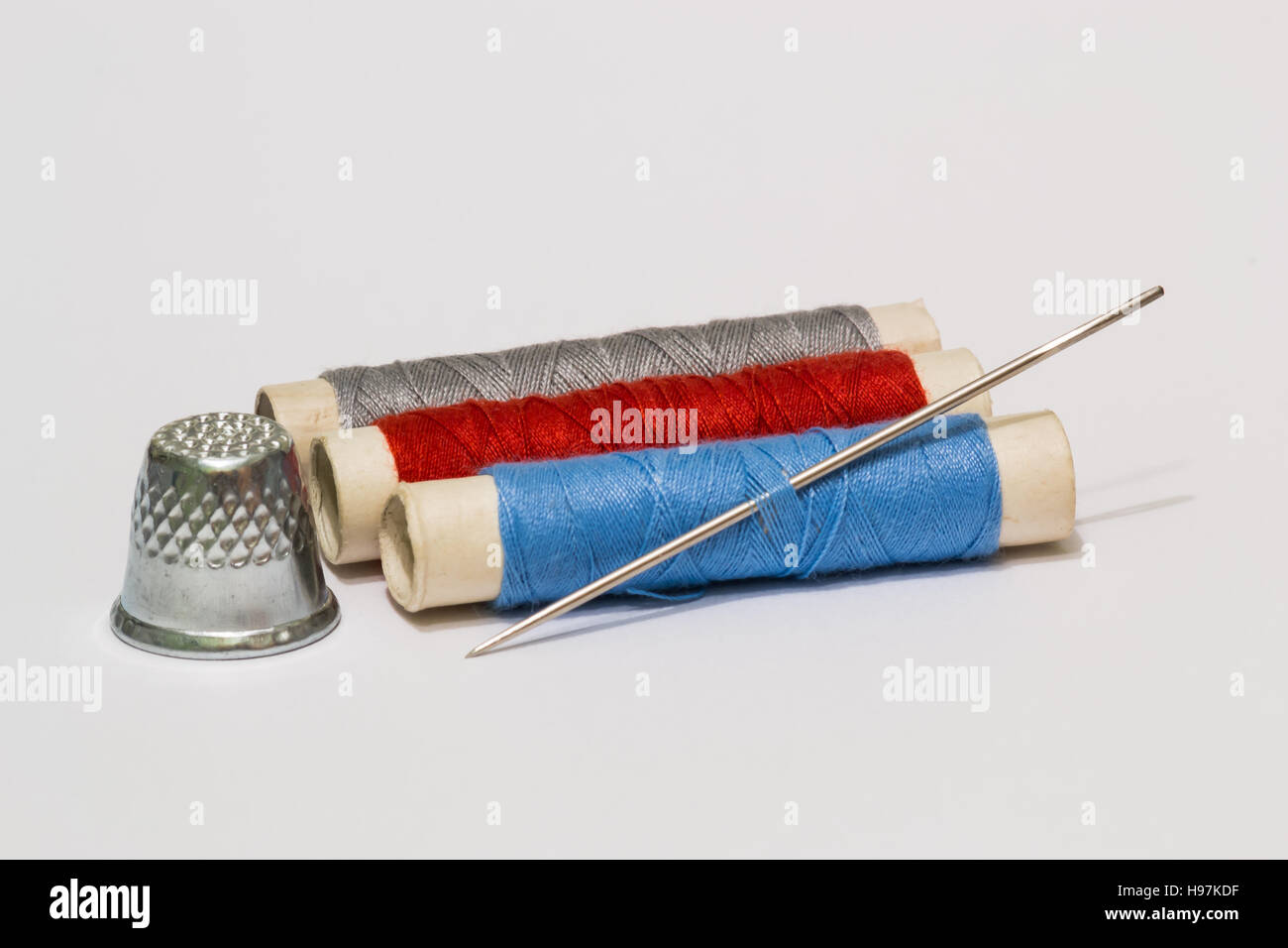 Old vintage sewing accessories. Needle with threads. Scissors. Centimeter.  Thimble Stock Photo - Alamy