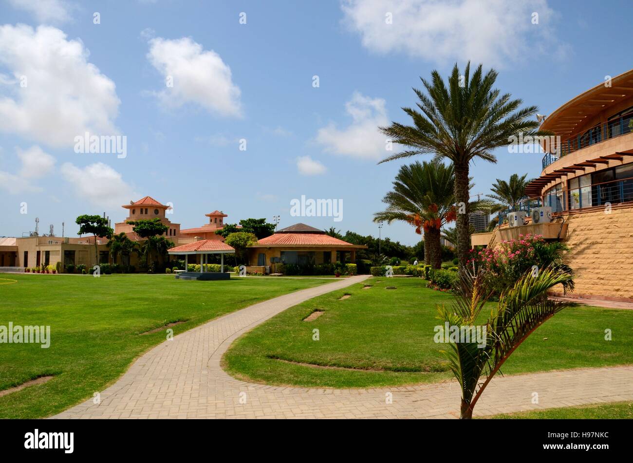 Clubhouse and gardens with pedestrian path at DHA Golf club Karachi
