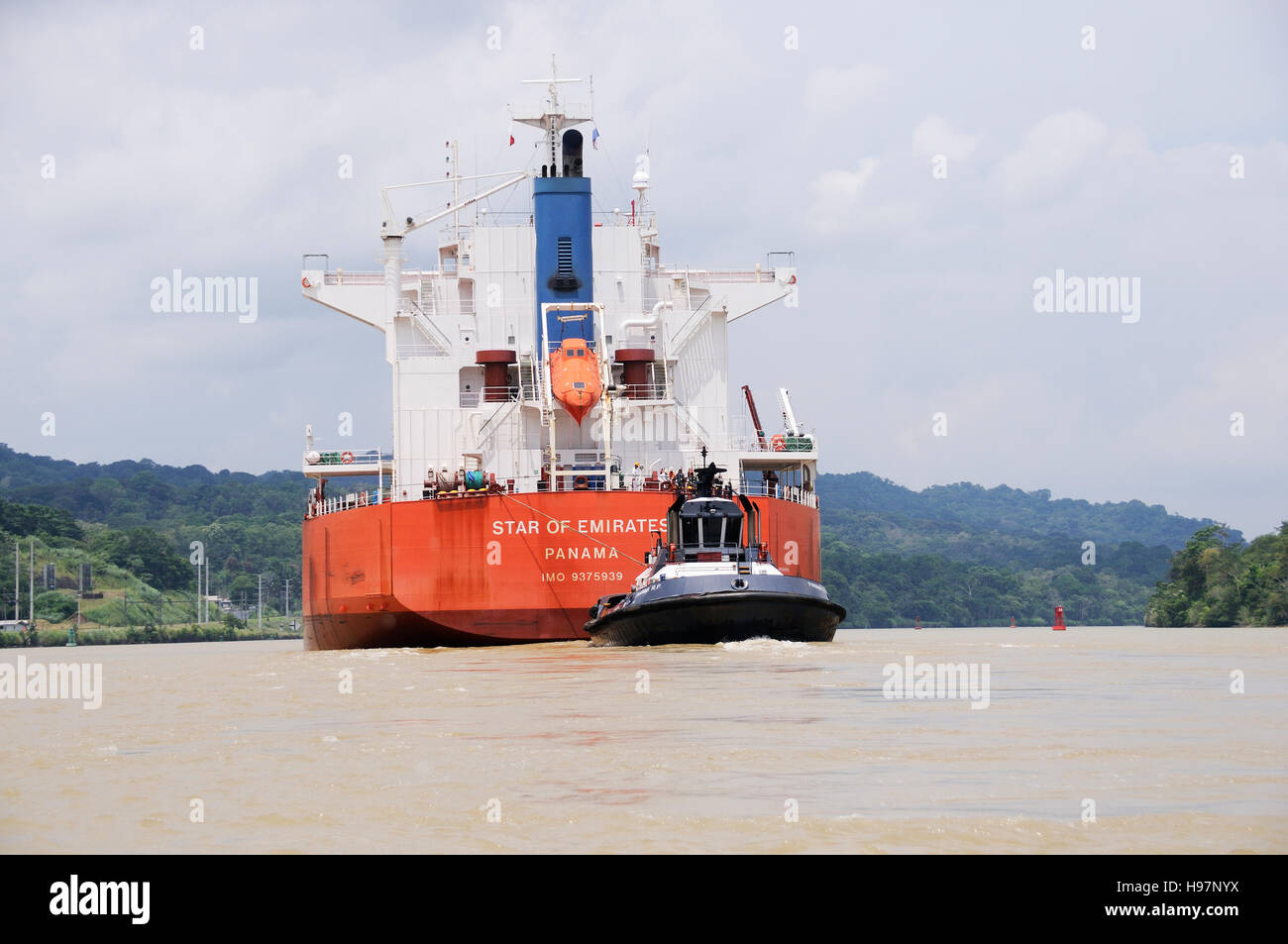 Tugboat towing, tuging a large tankship, Panama, Panama Canal Stock Photo