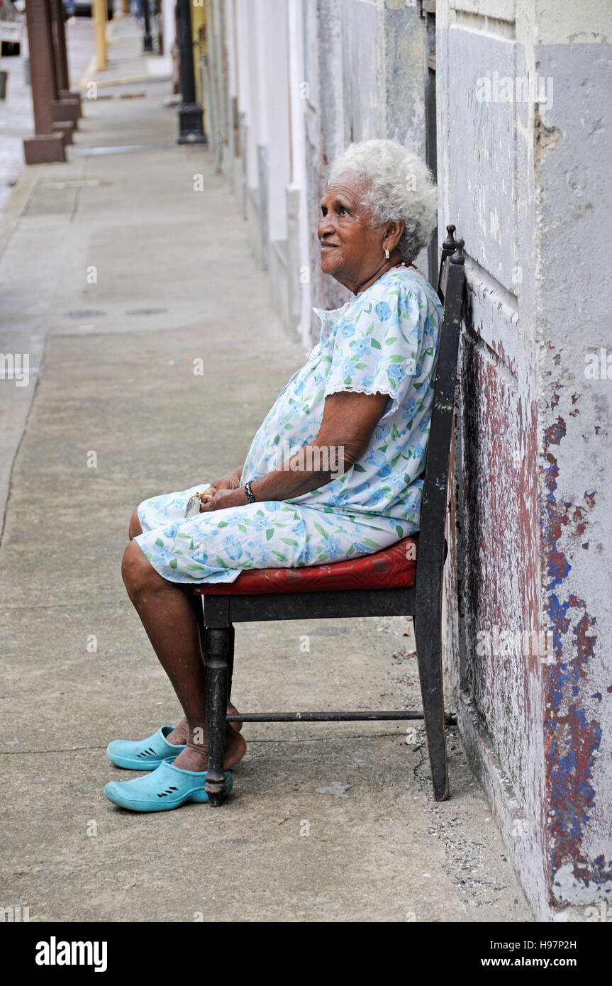 old woman sitting on chair in Panama City, Panama Stock Photo