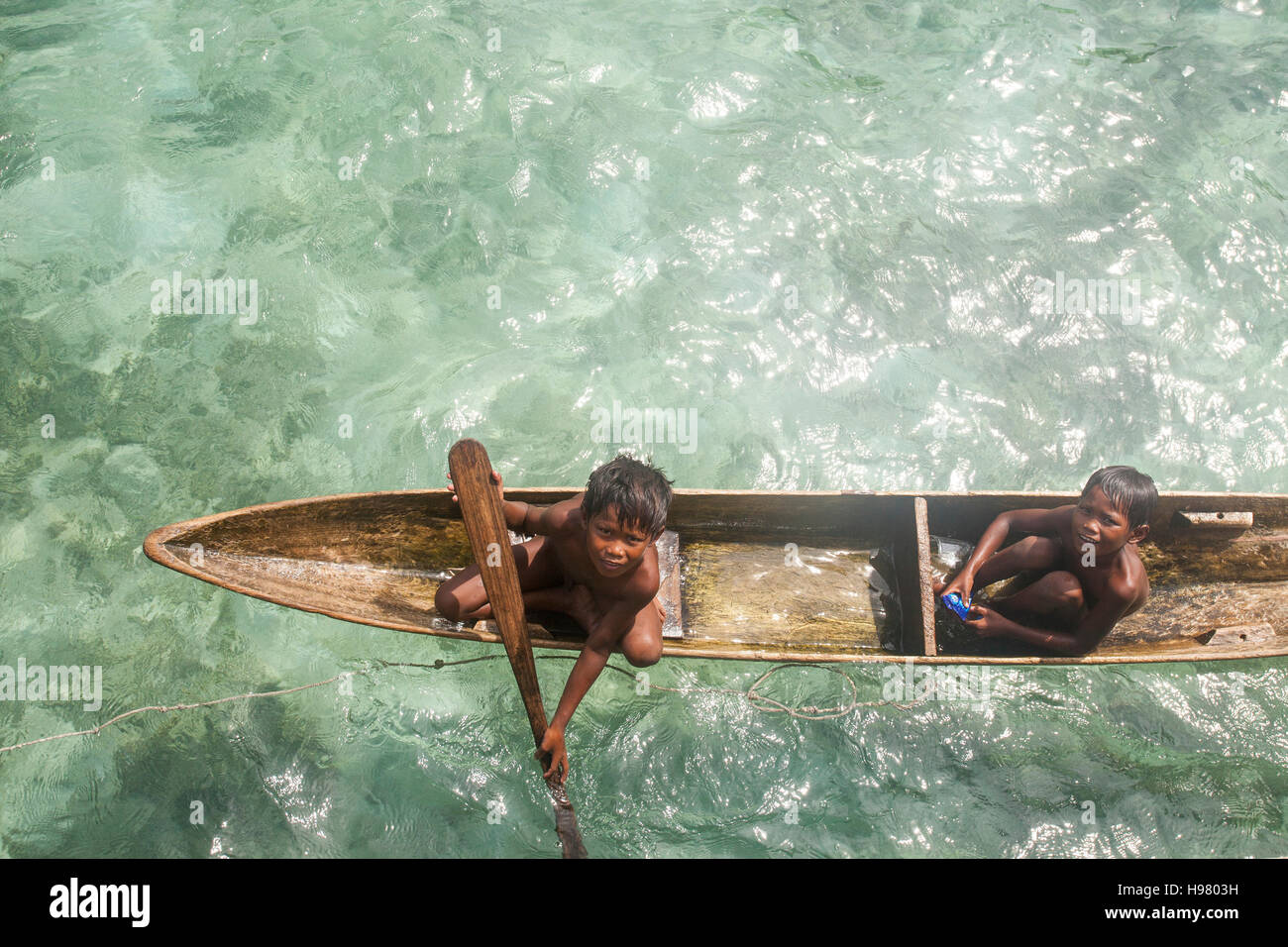 Borneo Sea Gypsy kids on a canoes in Bodgaya Mabul Sipadan Island