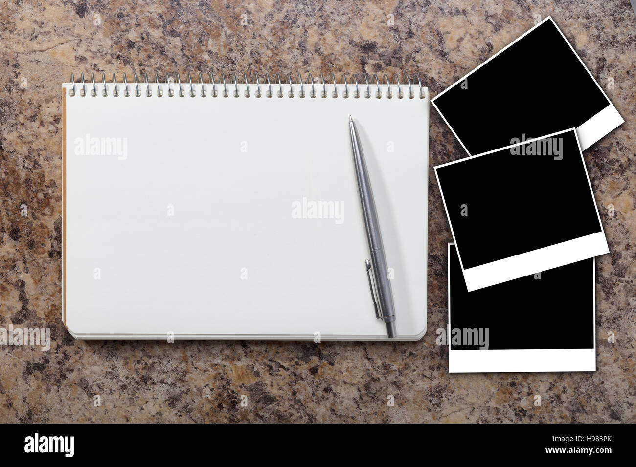 Notebook with empty photograph on a granite background Stock Photo