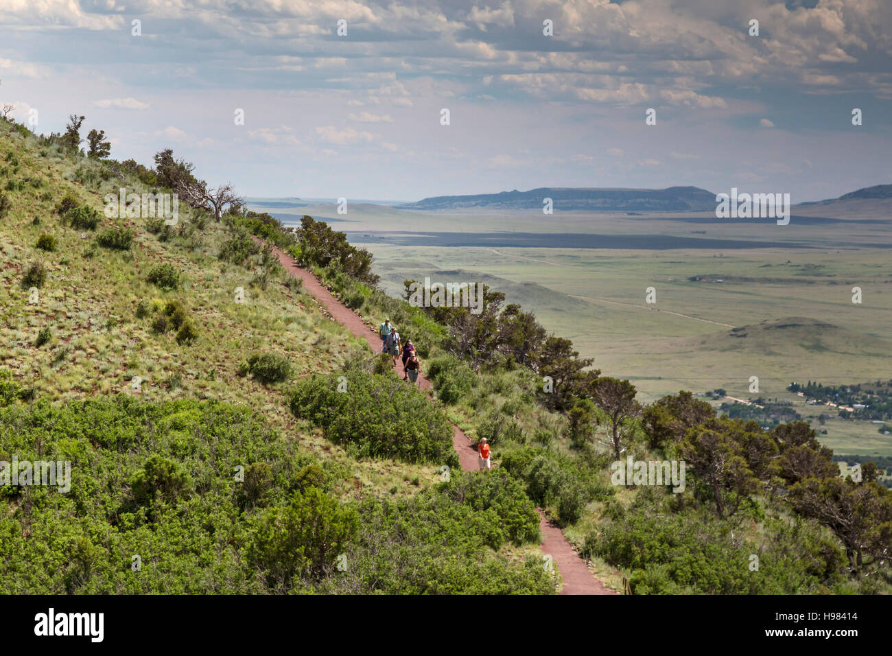 Capulin, New Mexico - Tourists hiking on the Crater Rim Trail at Capulin Volcano National Monument. Stock Photo