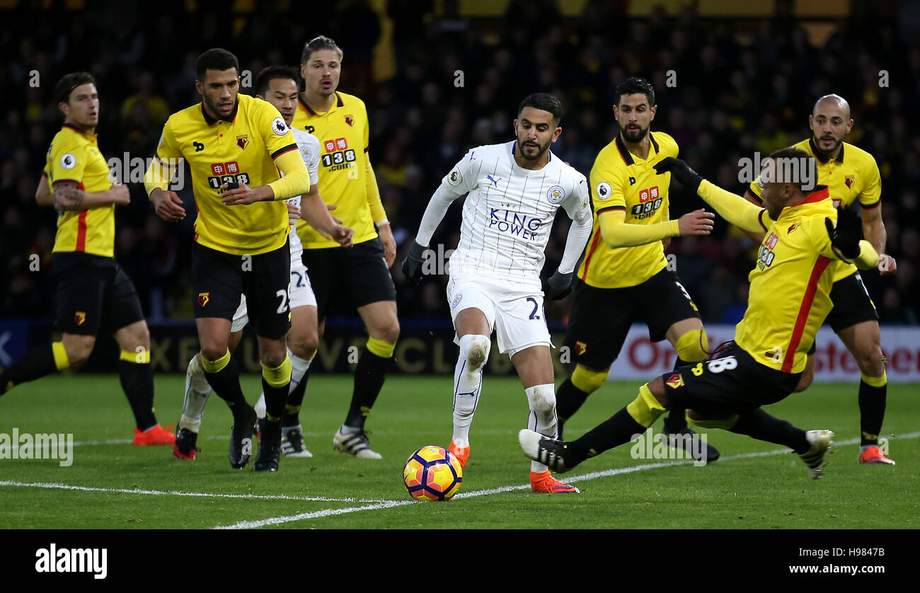 Leicester City's Riyad Mahrez (centre) and Watford's Juan Camilo Zuniga (right) battle for the ball during the Premier League match at Vicarage Road, Watford. Stock Photo