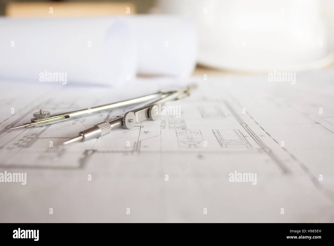 Desk of Engineering project in construction site or office with mining light.Construction concept.Engineering tools.Vintage tone retro filter effect,s Stock Photo