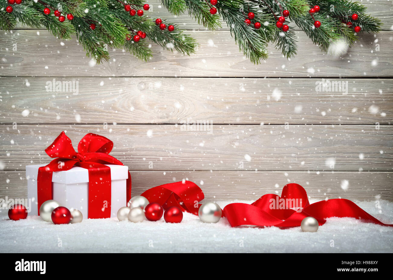 Christmas wood background with a white gift box, red bow and ribbon Stock Photo: 126187123 - Alamy