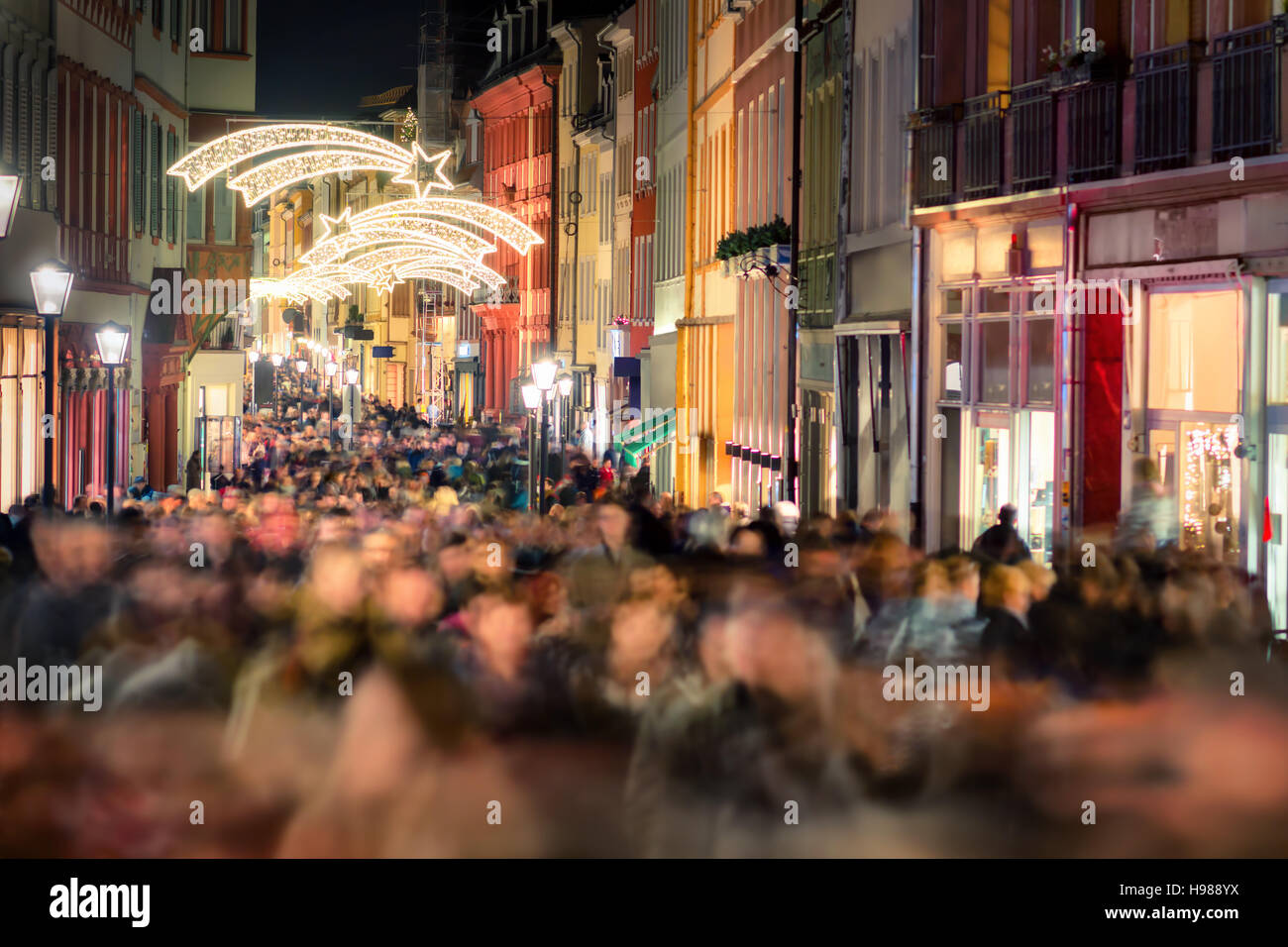 Large crowd of people hustling and shopping in a pedestrian area in Heidelberg, Germany, for Christmas Stock Photo