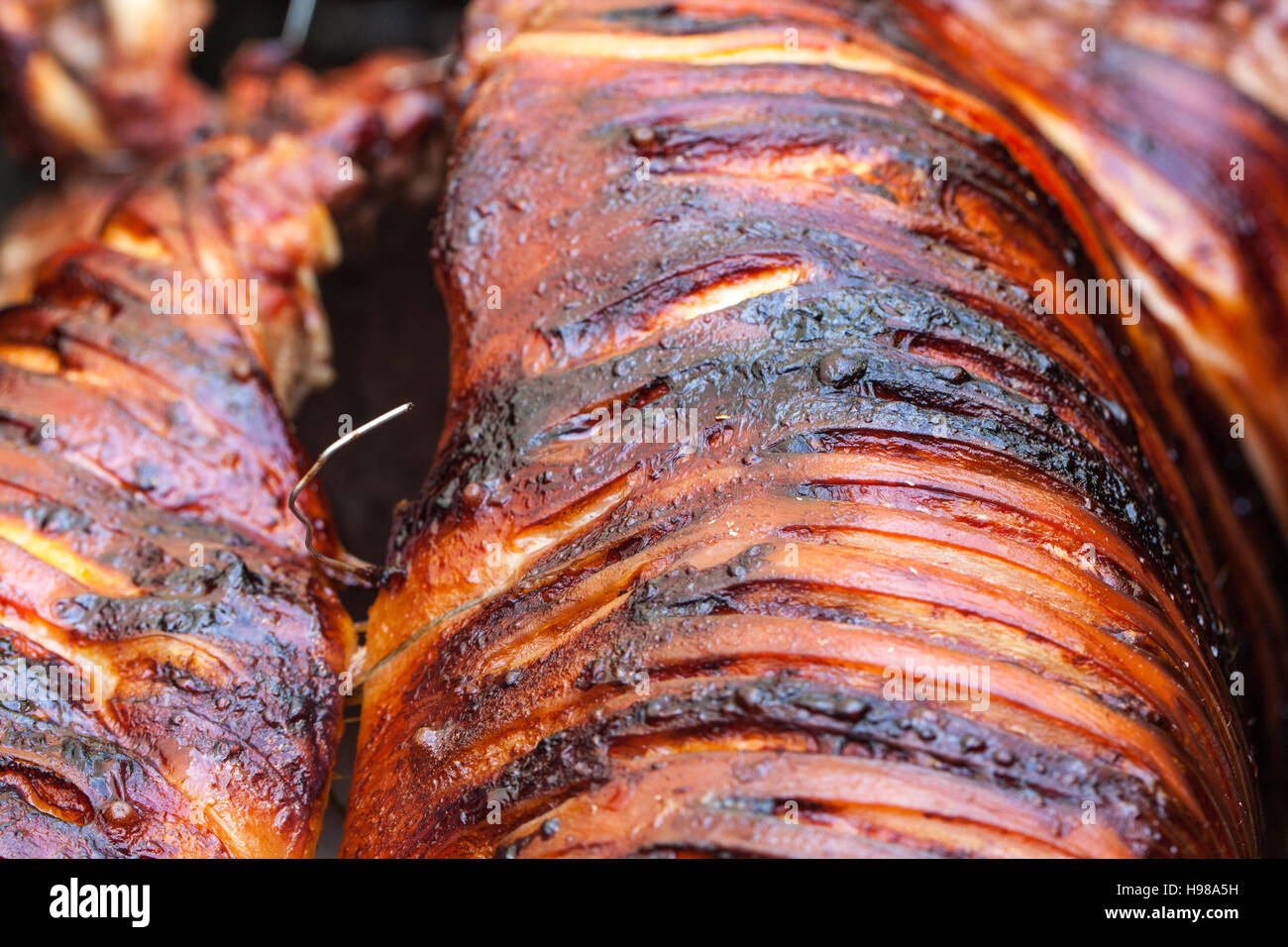 Hog Roast whole pig cooked over charcoal for a large gathering Stock