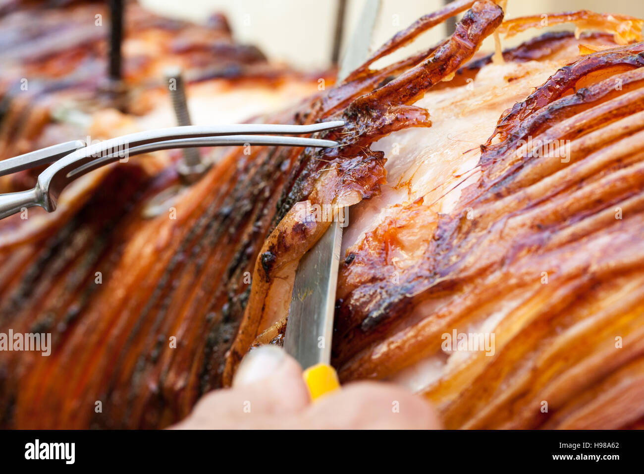 Hog Roast whole pig cooked over charcoal for a large gathering Stock