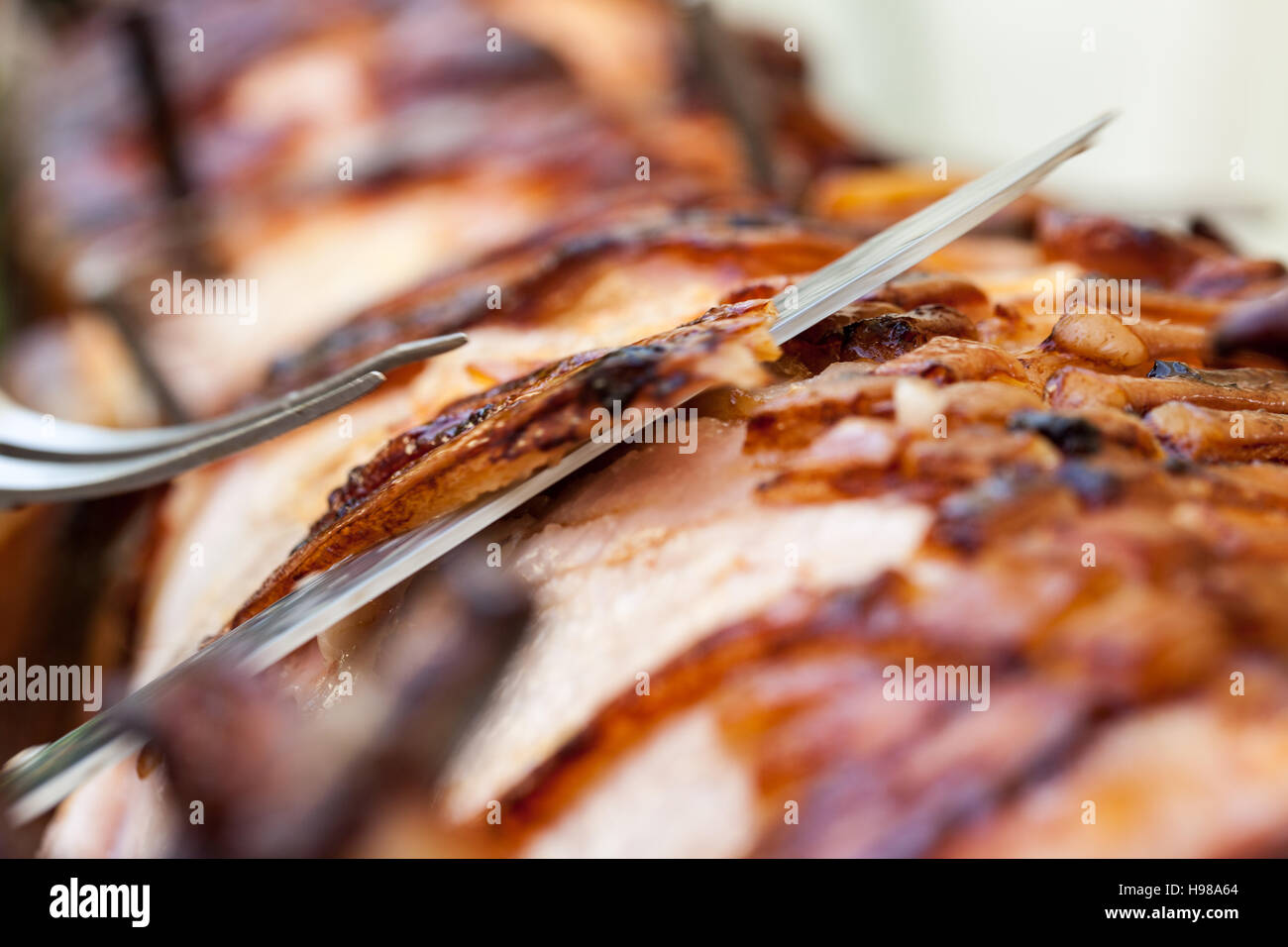 Hog Roast whole pig cooked over charcoal for a large gathering Stock