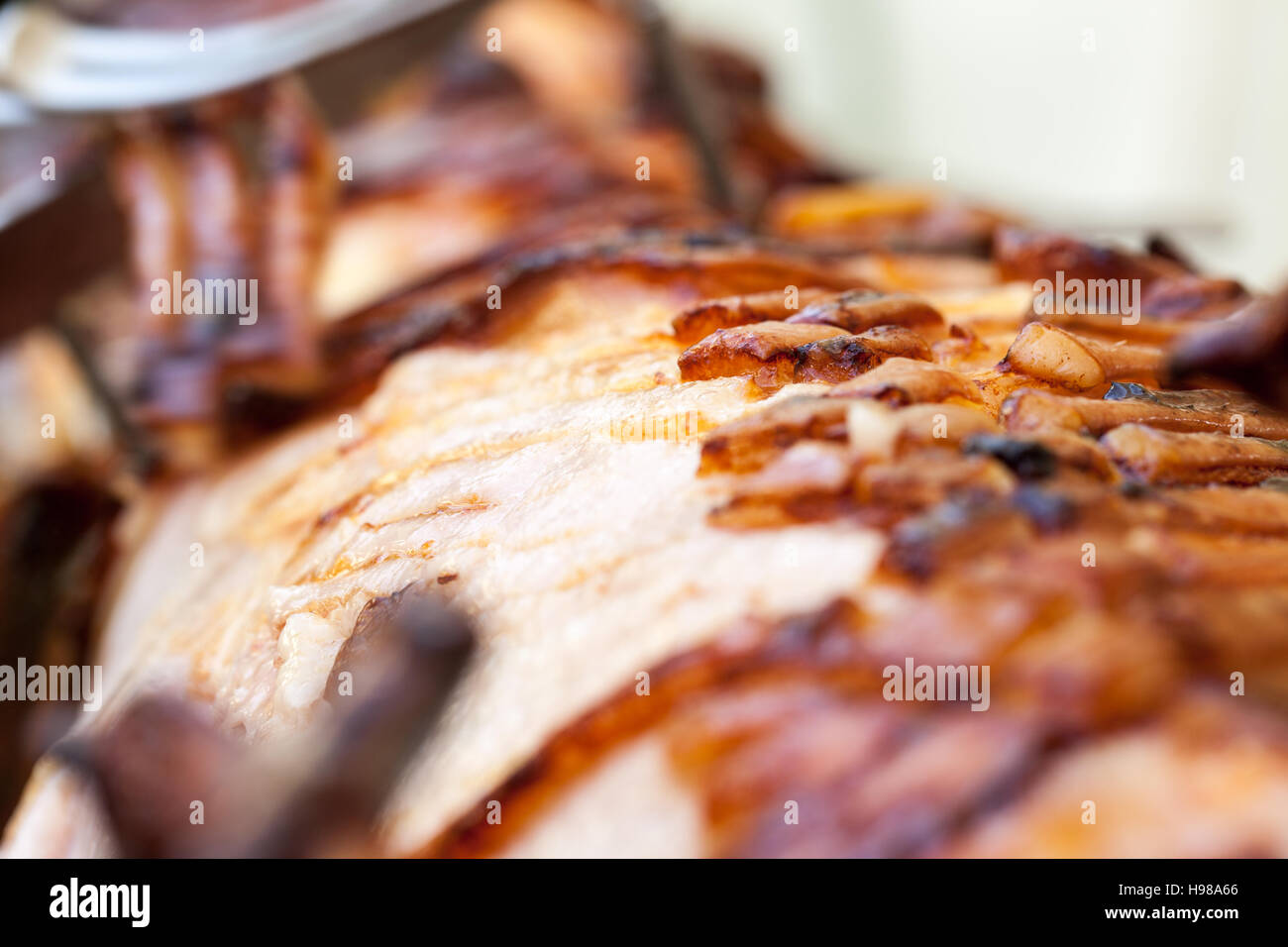 Hog Roast whole pig cooked over charcoal for a large gathering Stock