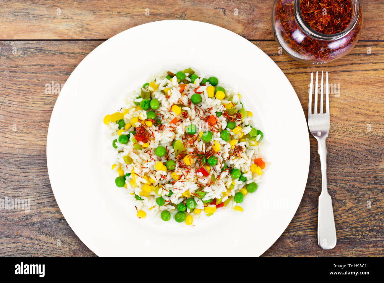 Rice with Corn, Peas, Peppers and Saffron Studio Photo Stock Photo - Alamy