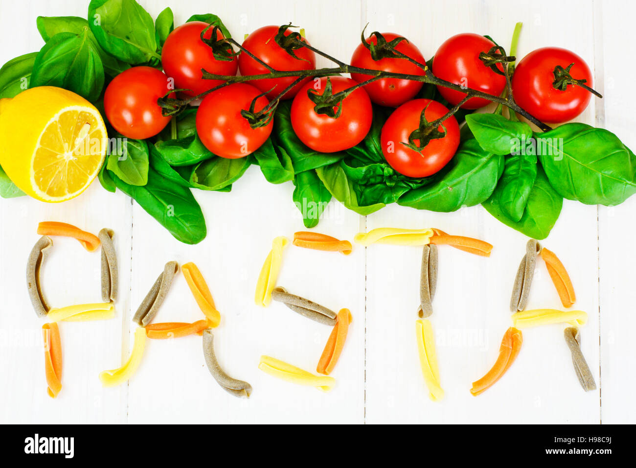 Basil, Red Cherry Tomato with Pasta on White Woody Background Studio