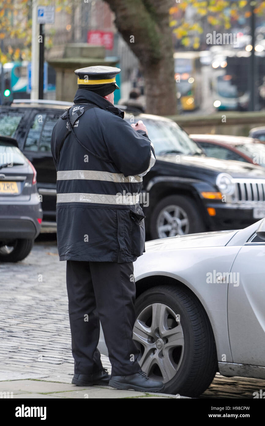 Parking attendant issuing a ticket, Liverpool, Merseyside, UK. Stock Photo