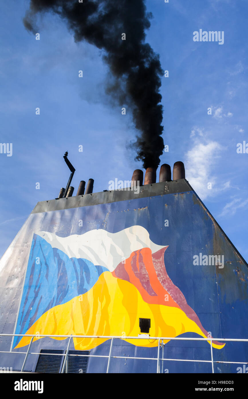 Black smoke from a ships funnel with blue sky in the background. Stock Photo