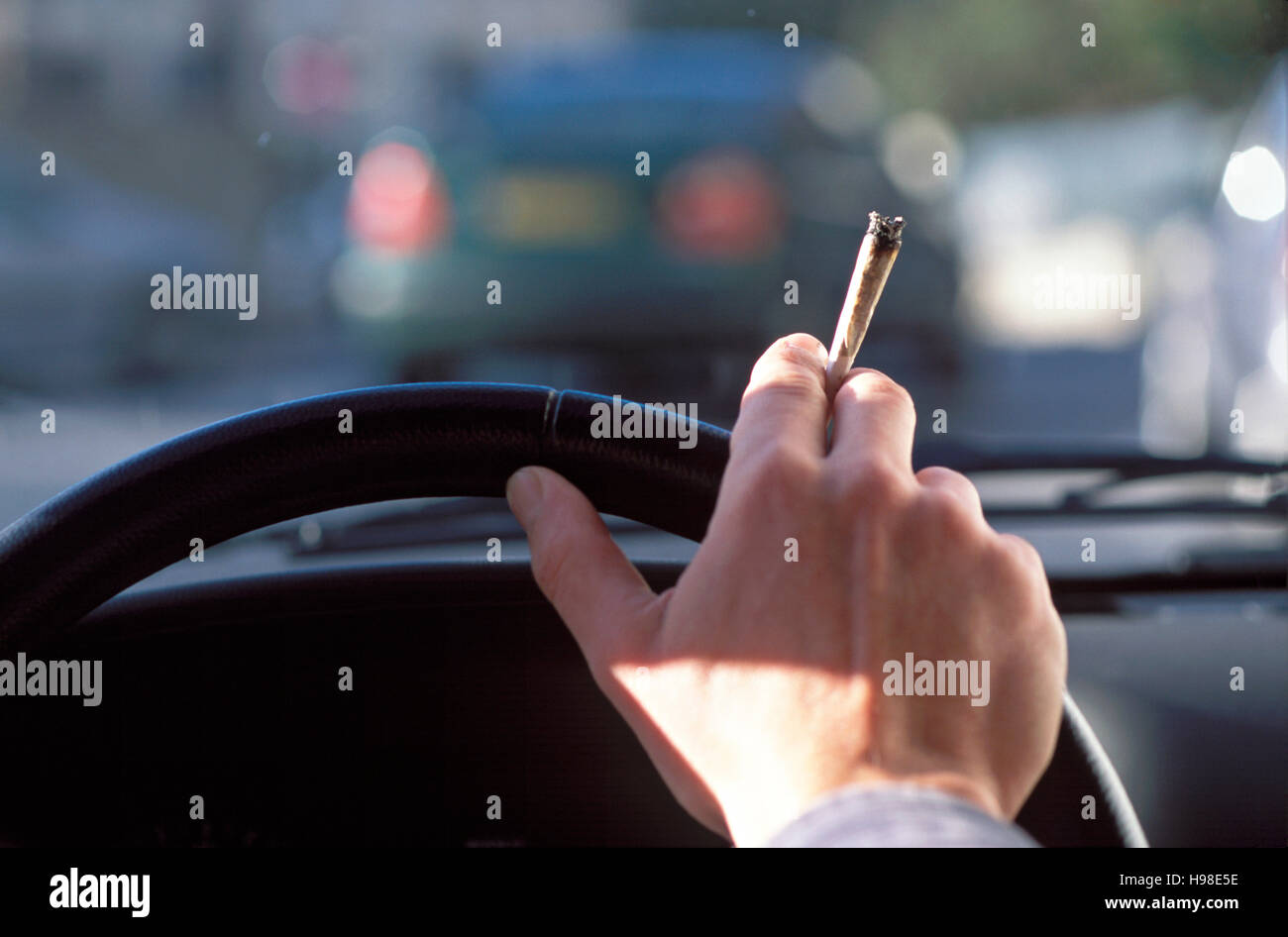 Driver smoking a joint Stock Photo